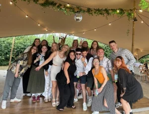 Team members of British Solar Renewables gathered together under a gazebo for a group photo