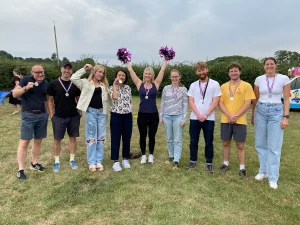 Members of the British Solar Renewables team stood on the helipad of the office, celebrating team sports day wins